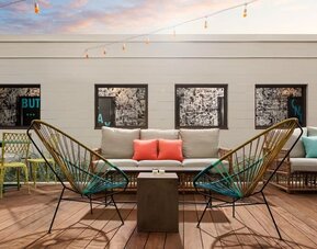 Rooftop outdoor seating area with stylish lounge furniture at Hotel Studio Allston.