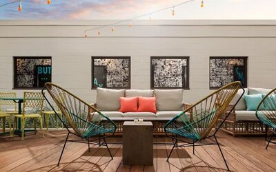 Rooftop outdoor seating area with stylish lounge furniture at Hotel Studio Allston.