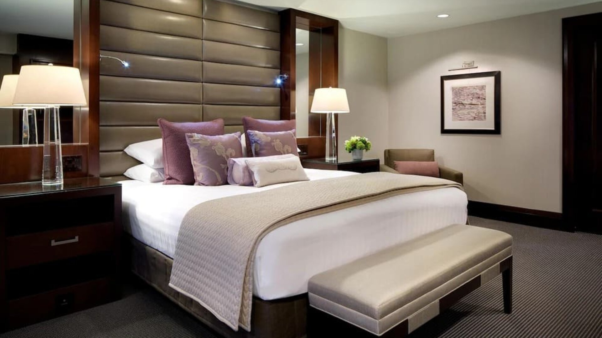 Luxury guest room with king bed, padded headboard, upholstered bench, and elegant neutral décor at Hyatt Regency Boston.