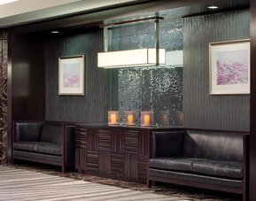 Sophisticated lobby seating area with dark wood accents and decorative lighting at Hyatt Regency Boston.