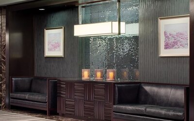 Sophisticated lobby seating area with dark wood accents and decorative lighting at Hyatt Regency Boston.