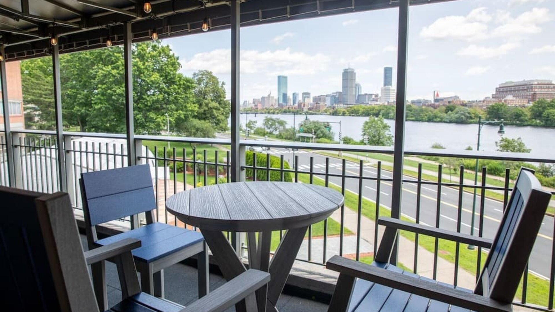 Outdoor terrace seating area with panoramic river and Boston skyline views at Hyatt Regency Boston/Cambridge.