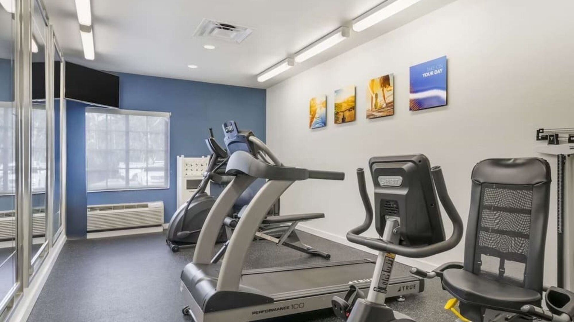 Bright fitness center featuring cardio equipment and exercise machines at Comfort Inn & Suites Port Charlotte-Punta Gorda.