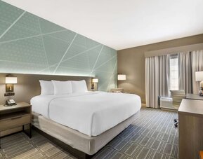 Contemporary king guest room with workspace, soft lighting, and modern décor at Comfort Inn & Suites Port Charlotte-Punta Gorda.