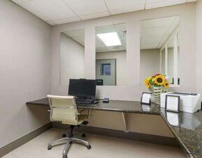 Compact business center with desktop workstation, printer access, and granite work surfaces at Comfort Inn & Suites Port Charlotte-Punta Gorda.