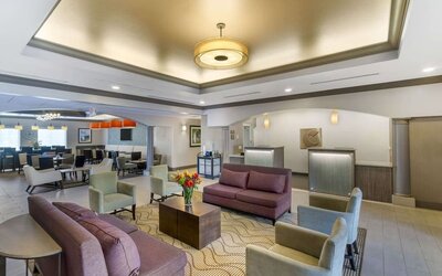 Spacious hotel lobby with comfortable seating, reception area, and modern lighting at Comfort Inn & Suites Port Charlotte-Punta Gorda.