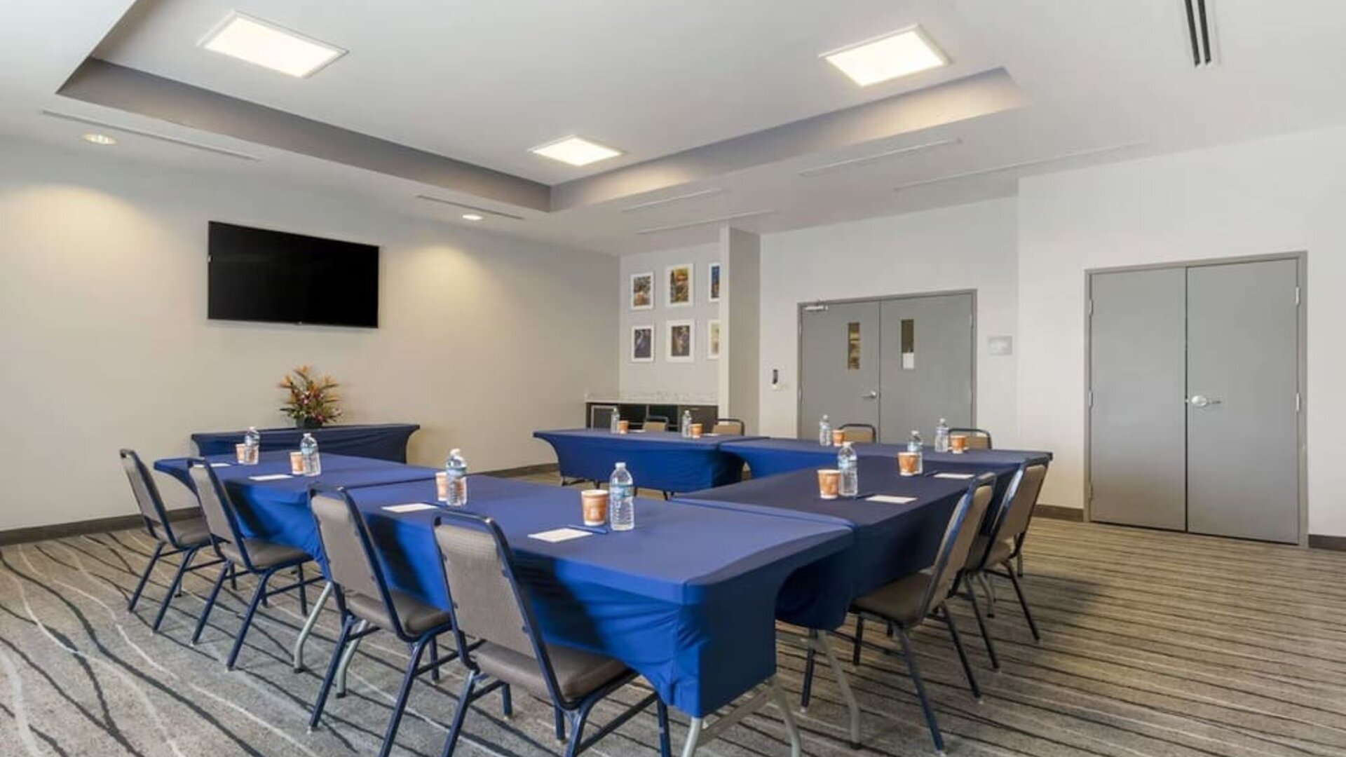 Meeting room with conference-style setup, presentation screen, and flexible event space at Comfort Inn & Suites Port Charlotte-Punta Gorda.