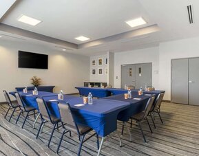 Meeting room with conference-style setup, presentation screen, and flexible event space at Comfort Inn & Suites Port Charlotte-Punta Gorda.