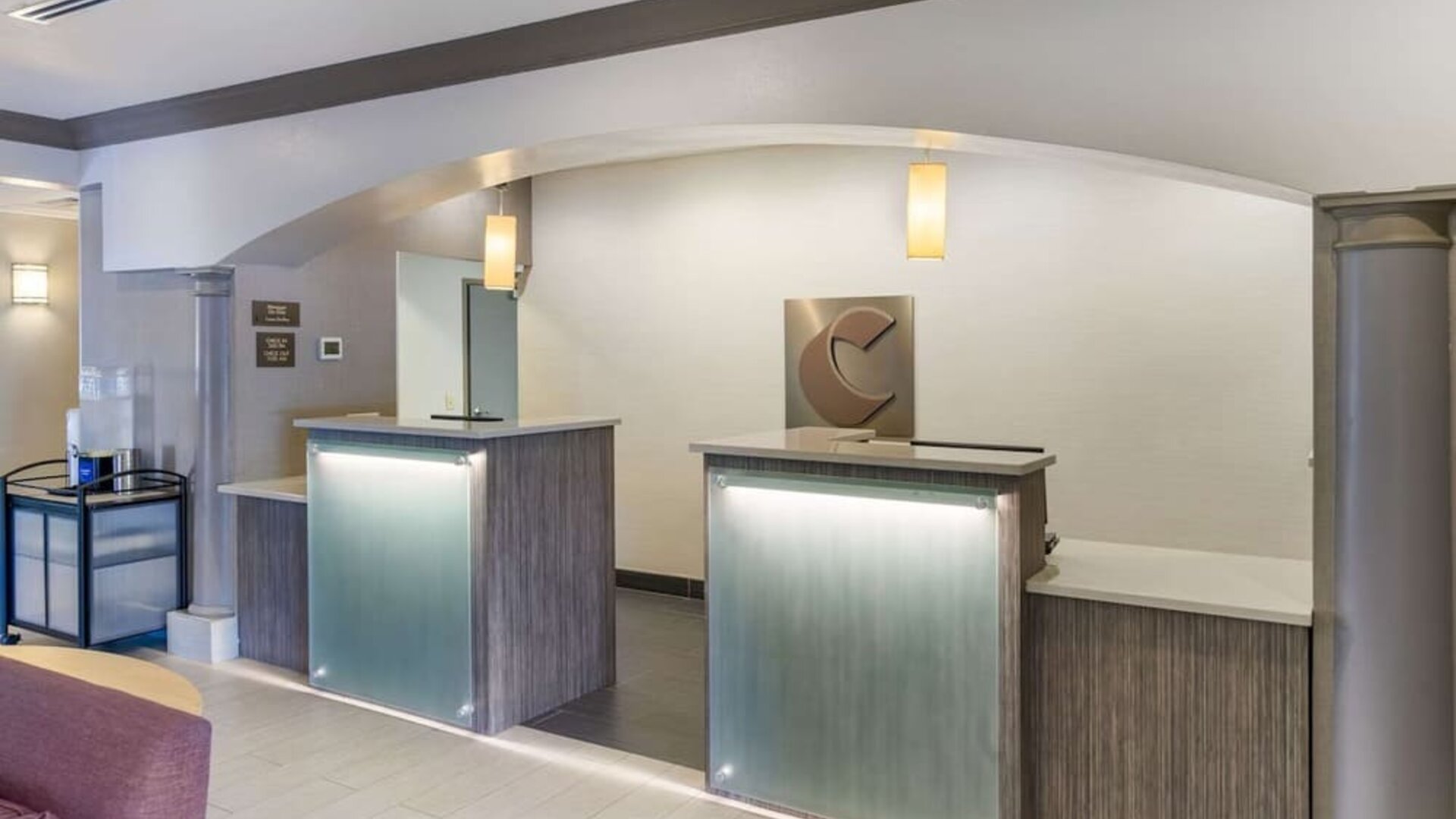 Modern reception desk area with illuminated counters and contemporary finishes at Comfort Inn & Suites Port Charlotte-Punta Gorda.