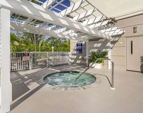 Outdoor hot tub beneath a shaded pergola at Comfort Inn & Suites Port Charlotte-Punta Gorda.