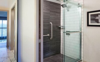 Modern glass-enclosed shower area with sleek tilework and contemporary bathroom design at Boston Marriott Newton.