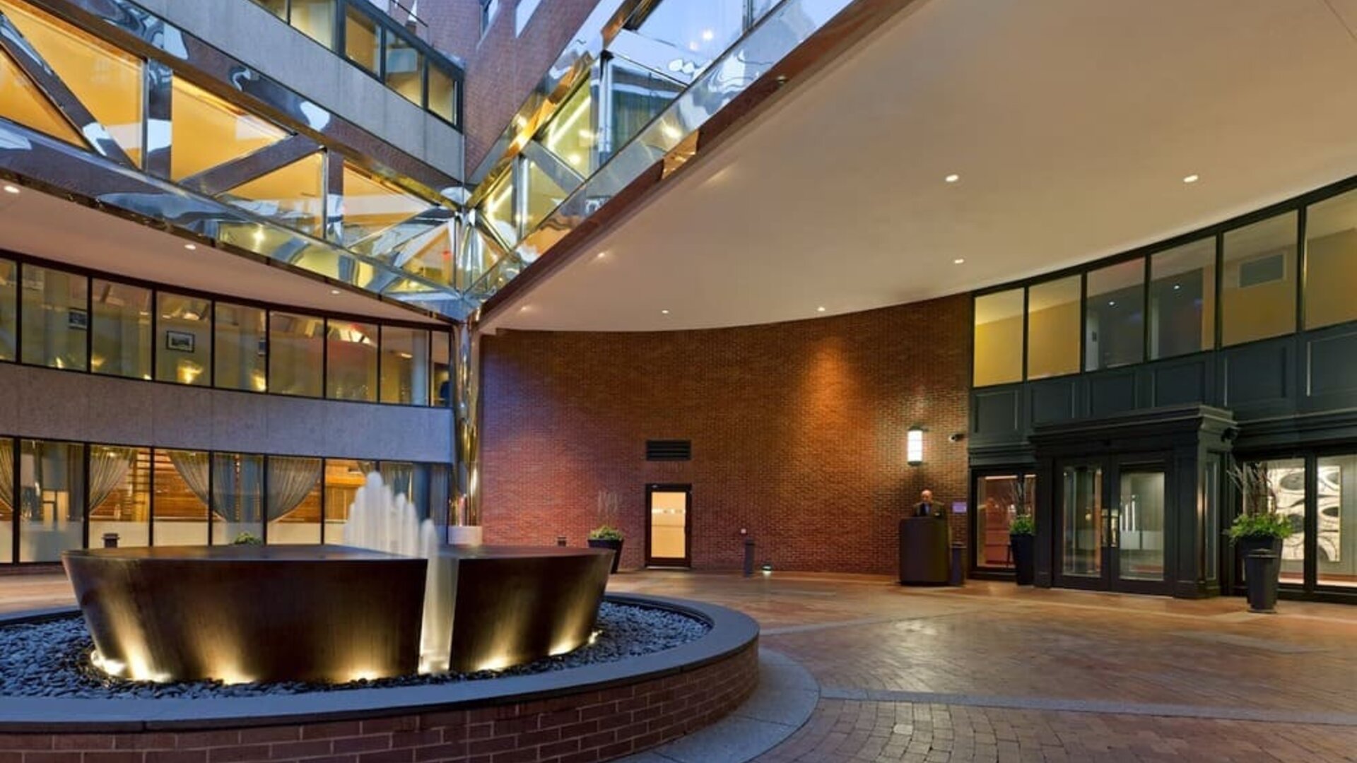 Grand hotel entrance courtyard with modern fountain feature and contemporary architectural design at The Bostonian Boston, A Millennium Hotel.