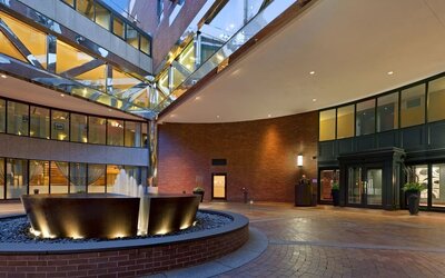 Grand hotel entrance courtyard with modern fountain feature and contemporary architectural design at The Bostonian Boston, A Millennium Hotel.