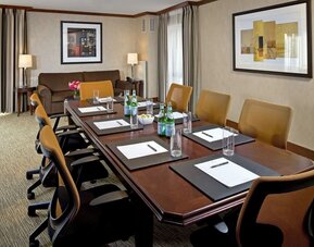 Professional meeting room with conference table setup, ergonomic seating, and business-friendly amenities at The Bostonian Boston, A Millennium Hotel.