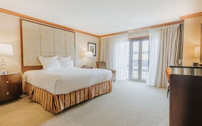 Bright king guest room featuring elegant décor, soft natural lighting, and contemporary furnishings at The Bostonian Boston, A Millennium Hotel.