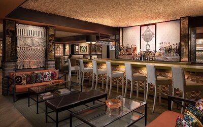 Sophisticated hotel bar featuring handcrafted décor, comfortable seating, and a full-service beverage area at The Garland.