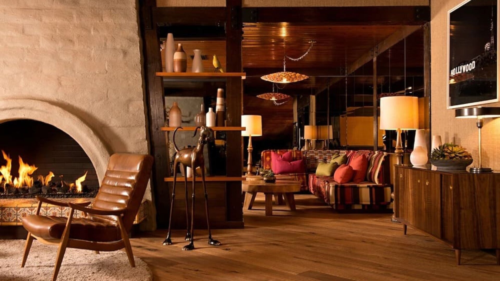 Elegant lobby seating area with a fireplace, wood finishes, and comfortable lounge spaces designed for relaxation at The Garland.