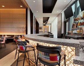 Stylish hotel bar and restaurant space offering contemporary décor, comfortable seating, and a vibrant setting for dining or evening drinks.