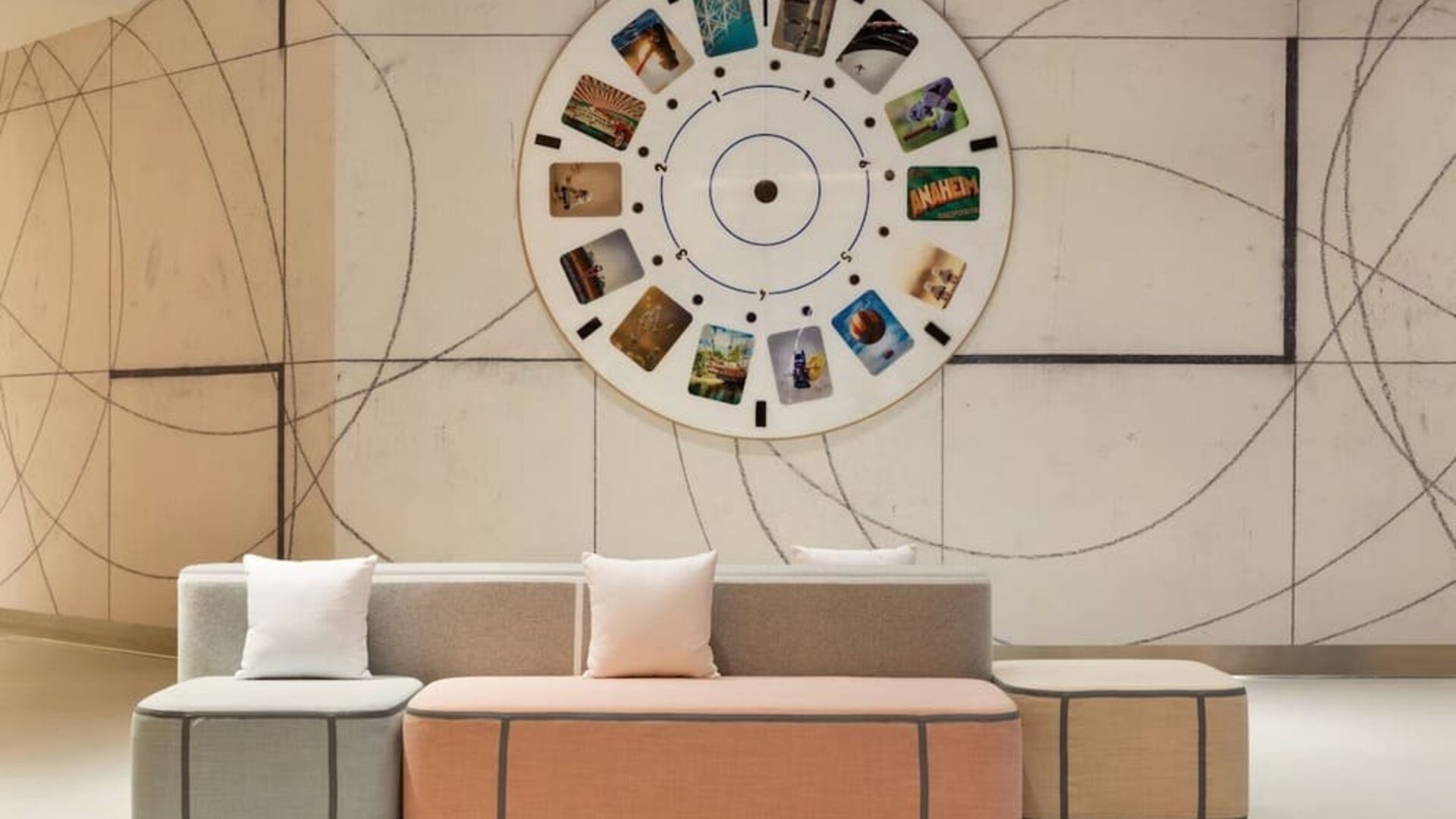 Modern lobby seating area showcasing artistic design elements, soft pastel furnishings, and a welcoming atmosphere for guests.