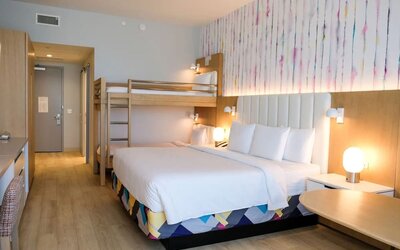 Family-friendly guest room featuring a king bed and built-in bunk beds, providing additional sleeping space for families traveling together.