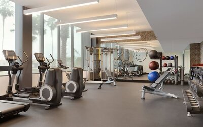 Fully equipped fitness center offering cardio machines, free weights, and strength-training equipment for guests maintaining their workout routines.