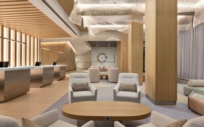 Sophisticated indoor lounge and reception area with contemporary furnishings, soft lighting, and open communal spaces.