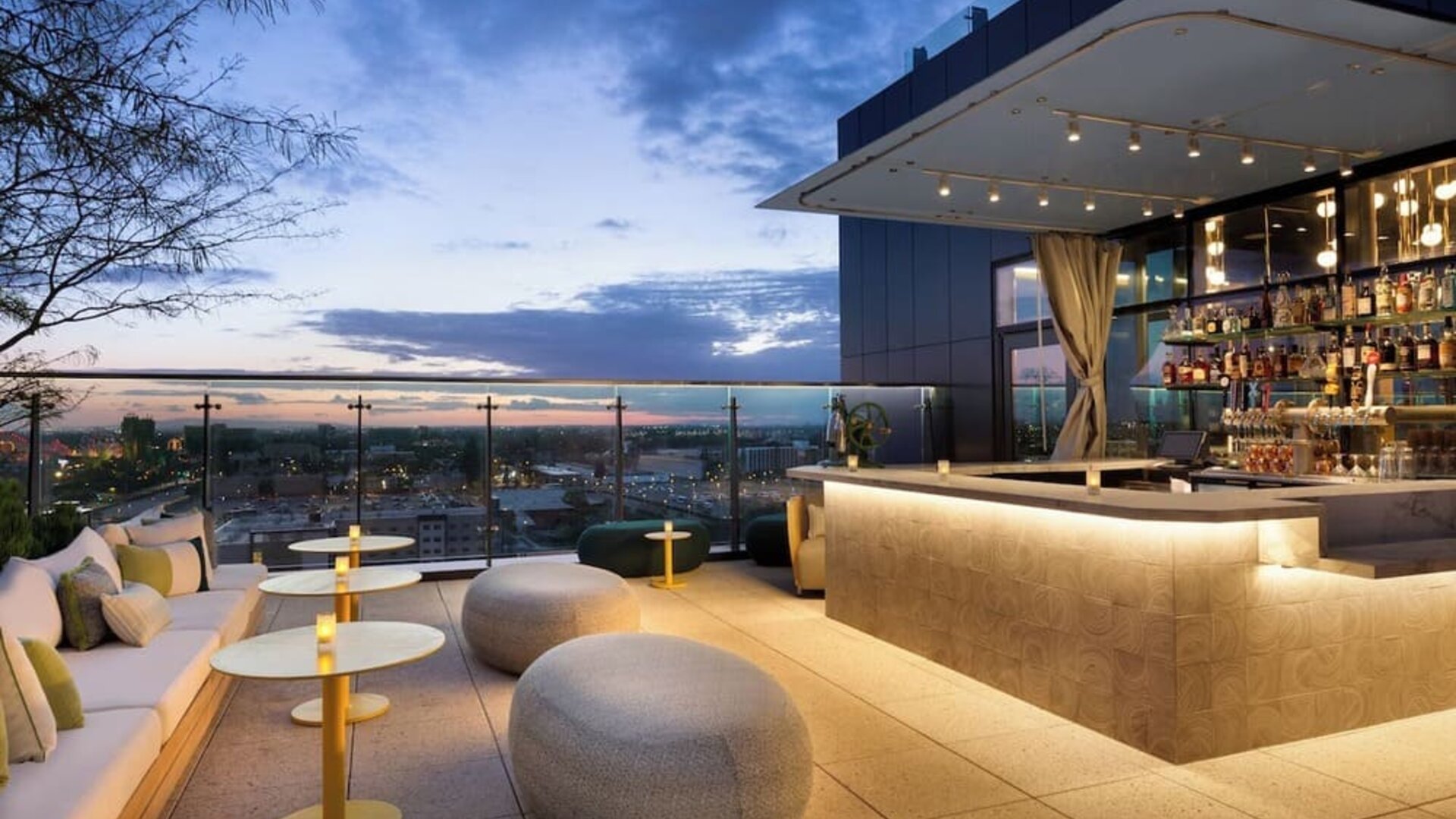 Rooftop bar and lounge with panoramic Anaheim views, stylish seating, ambient lighting, and an elegant setting for cocktails and evening gatherings.