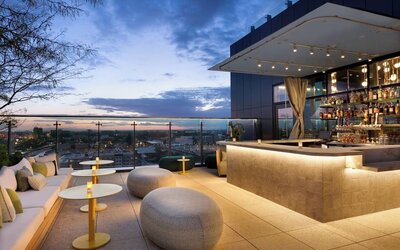 Rooftop bar and lounge with panoramic Anaheim views, stylish seating, ambient lighting, and an elegant setting for cocktails and evening gatherings.
