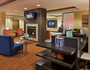 Lobby lounge area with fireplace and business center with computers and printer at Courtyard By Marriott Toronto Airport.