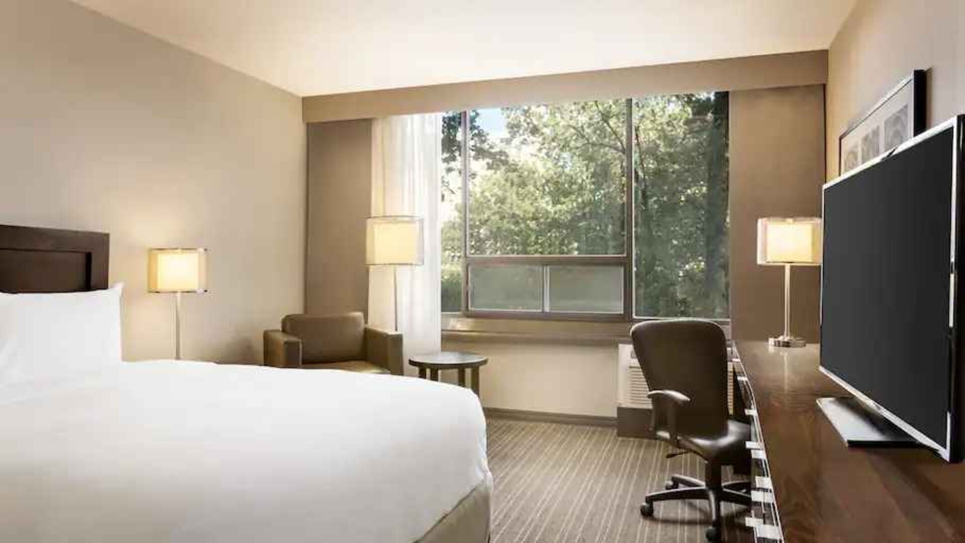 Comfortable deluxe queen room with window view at the Double Tree Toronto Airport West.
