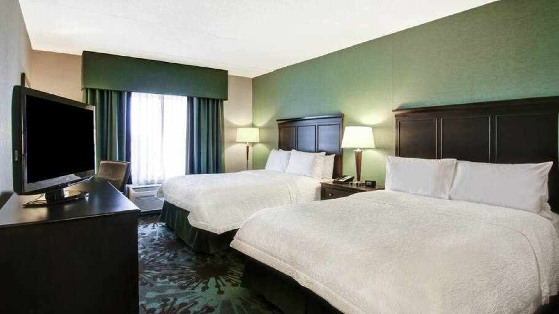 Day use twin room with TV, work desk and window view at the Hampton Inn by Hilton Toronto Airport Corporate Centre.