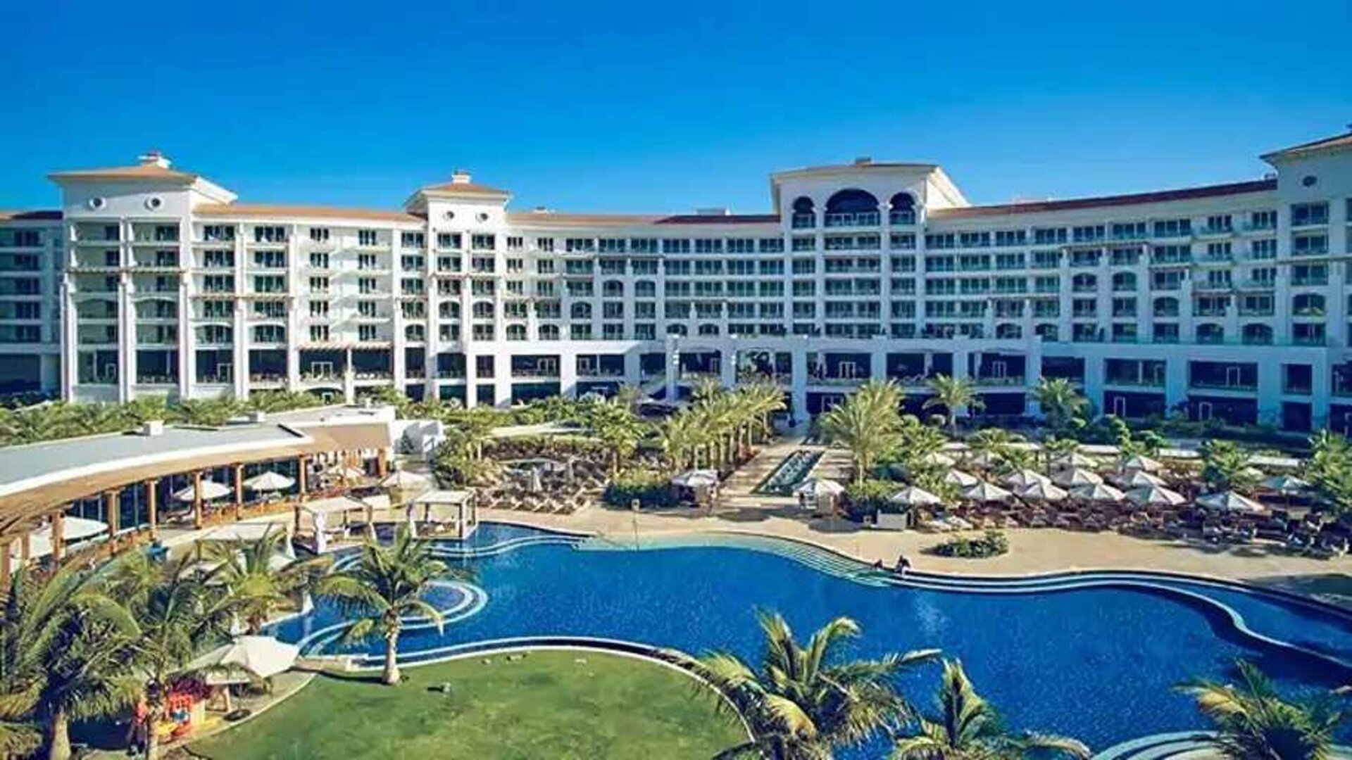 Beautiful outdoors with garden and pool at the Waldorf Astoria Dubai Palm Jumeirah.