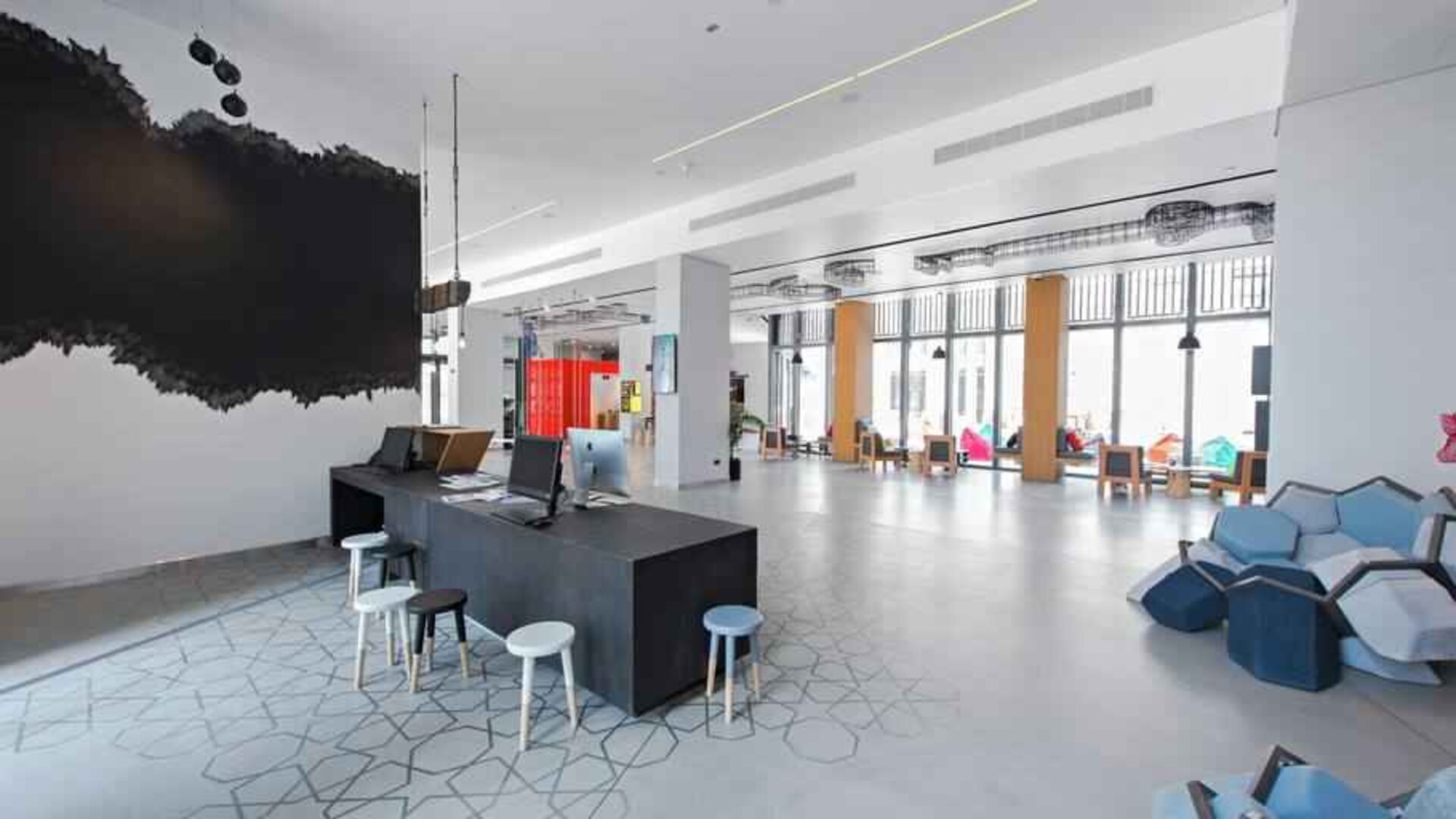 Spacious working station with desks and computers at the Hampton by Hilton Dubai Al Seef.