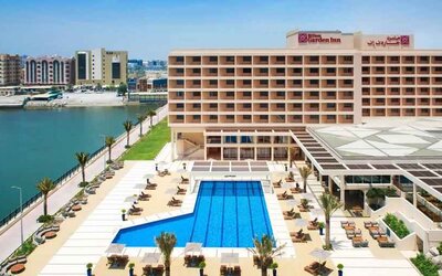 Relaxing outdoor pool area with outstanding creek view at the Hilton Ras Al Khaimah Beach Resort.
