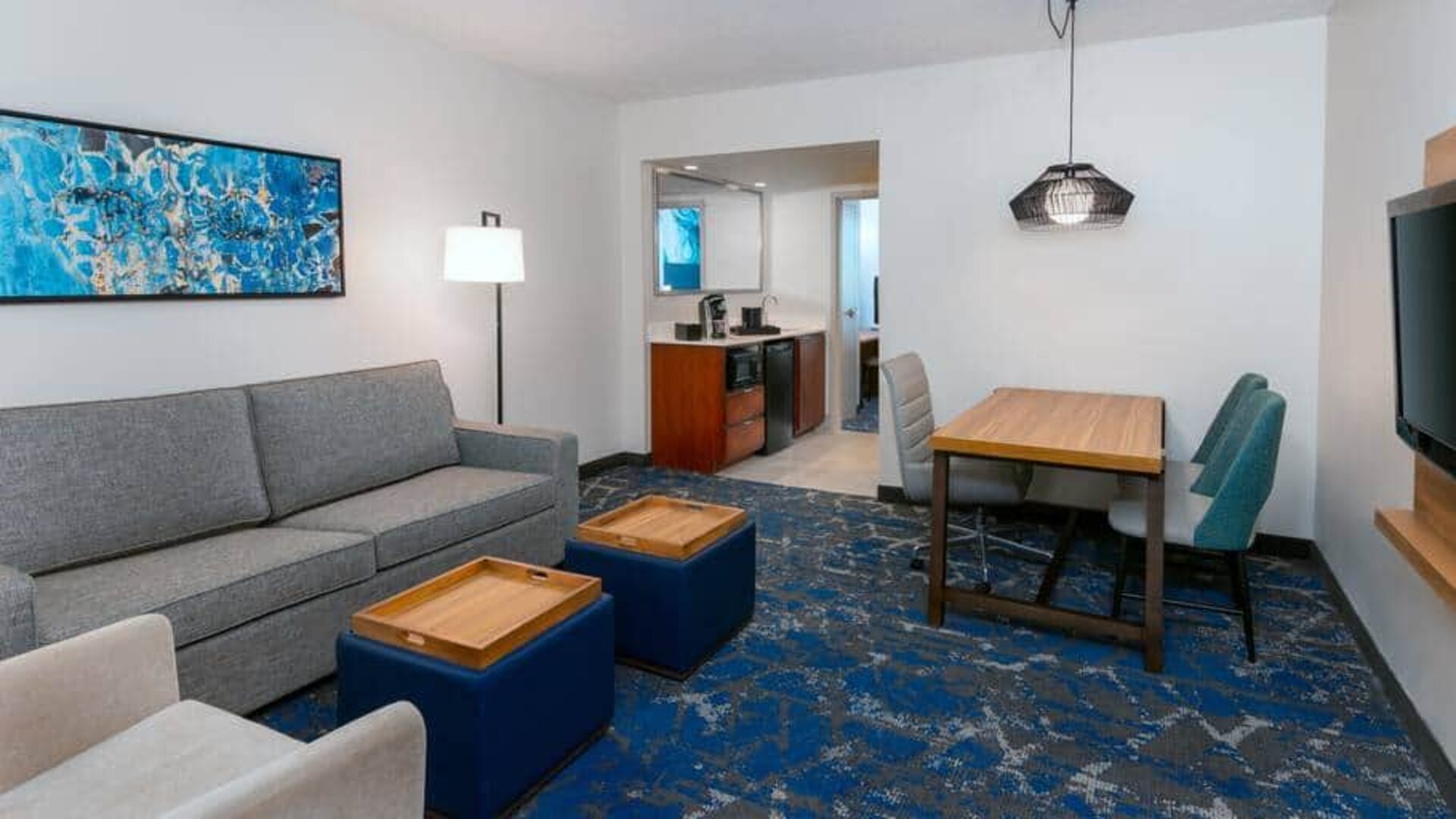 Spacious living area attached to kitchen at the Embassy Suites by Hilton Tampa USF