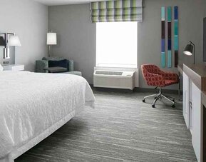 spacious king-sized room with TV and workspace at Hampton Inn Wichita Northwest.