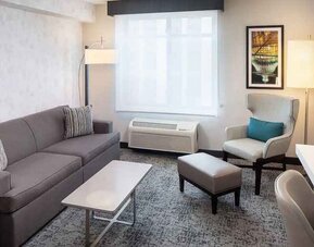 Bright-lit living area inside day use room at Hilton Garden Inn Washington DC Downtown.