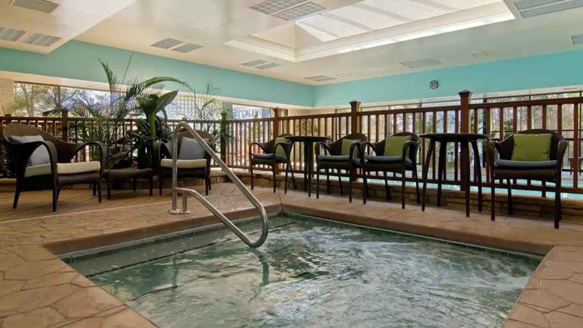 small indoor pool with comfortable social seating area at Hilton Raleigh North Hills.