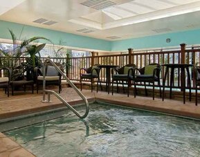 small indoor pool with comfortable social seating area at Hilton Raleigh North Hills.