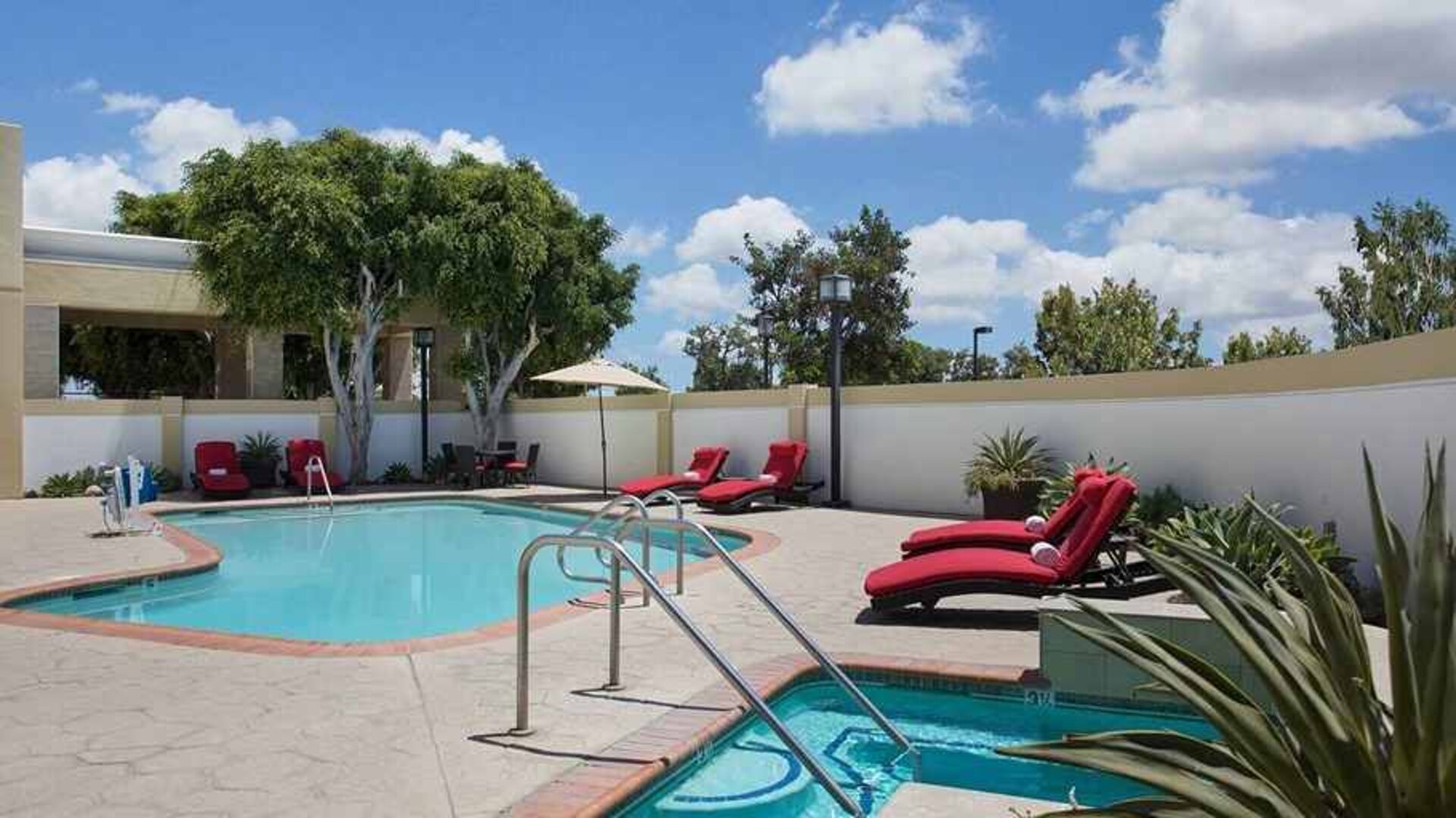 beautiful, outdoor pool with tanning beds and seating at DoubleTree by Hilton Los Angeles - Norwalk.