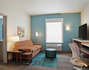 Living room in a king suite with working station at the Home2 Suites by Hilton Warminster Horsham.