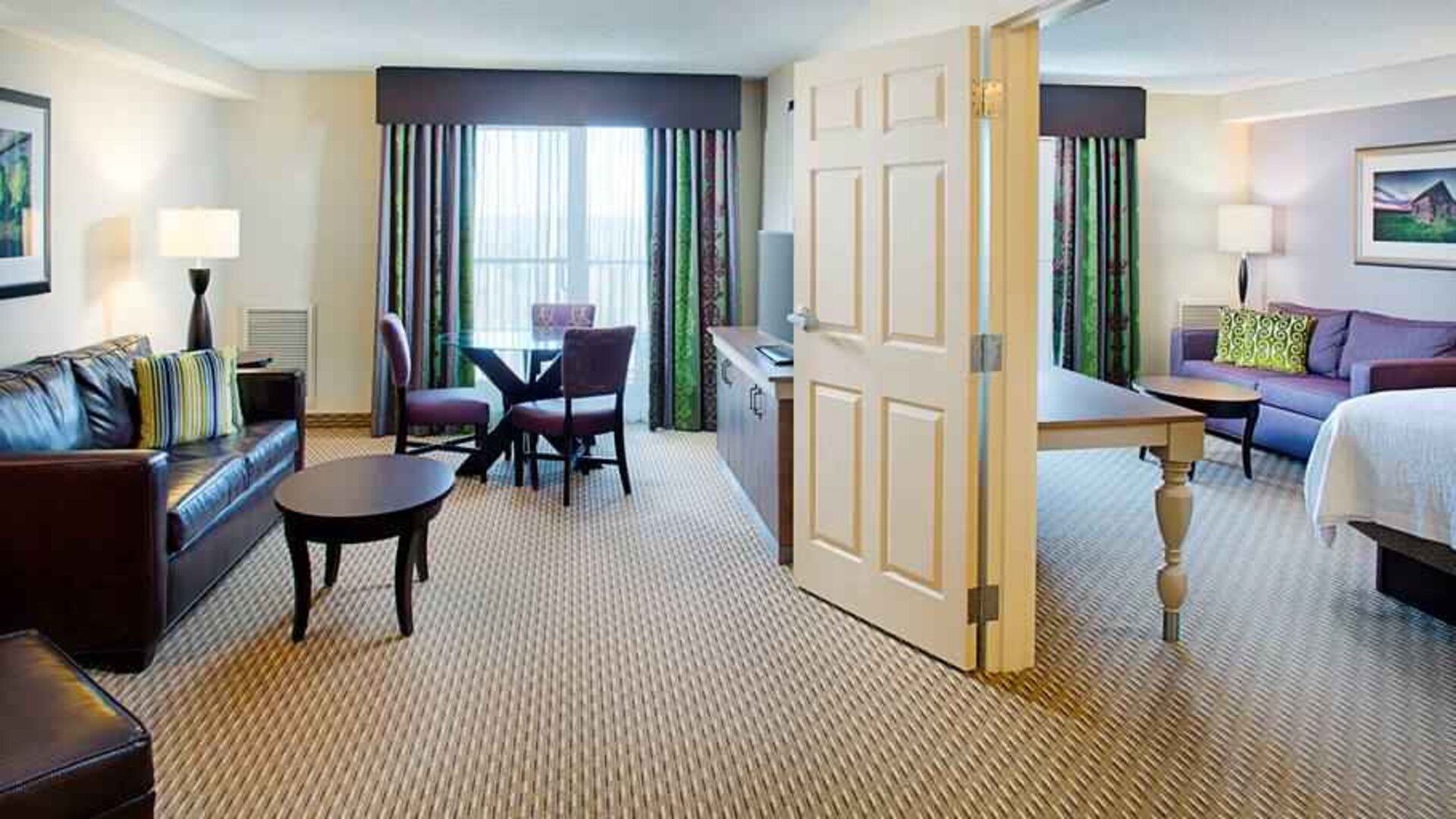 Spacious king suite with king bedroom and living room at the Hilton Garden Inn Hartford North/Bradley Intl Airport.