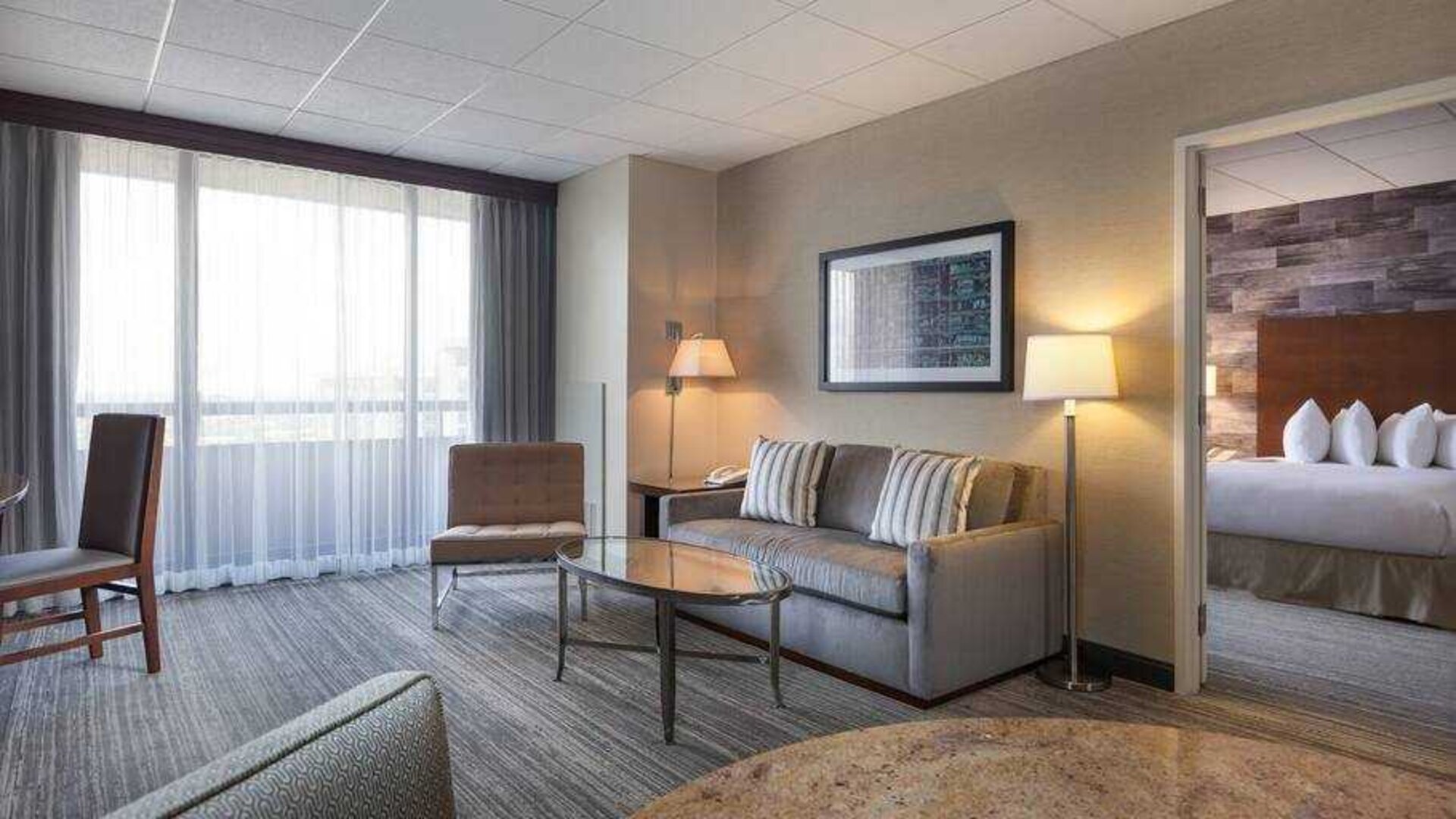 Living room with sofa and working station at the DoubleTree Suites by Hilton Houston by the Galleria.