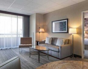 Living room with sofa and working station at the DoubleTree Suites by Hilton Houston by the Galleria.