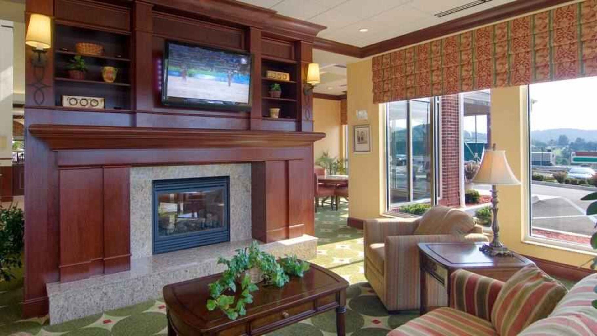 Elegant lobby area with fireplace and TV at the Hilton Garden Inn Clarksburg.