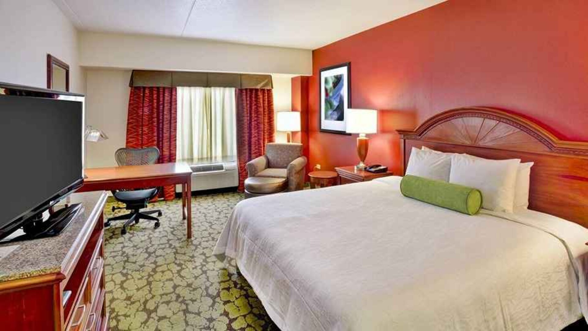 Beautiful king suite with TV, work desk, and lounge area at Hilton Garden Inn Chicago/Midway Airport.