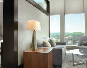 Spacious living room in a king suite room at the DoubleTree by Hilton Cedar Rapids Convention Complex.