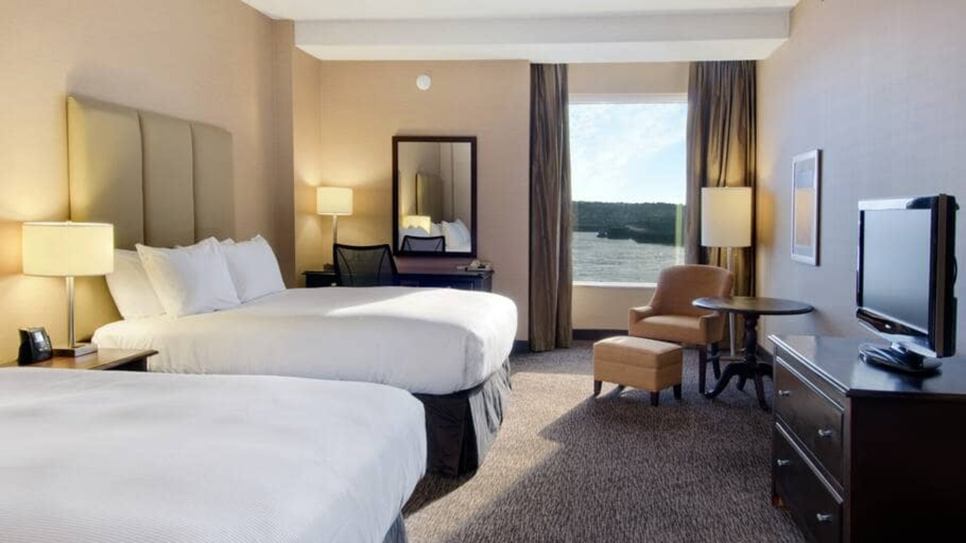 Spacious room with 2 queen beds, work desk and view of the harbour at the Hilton Saint John.