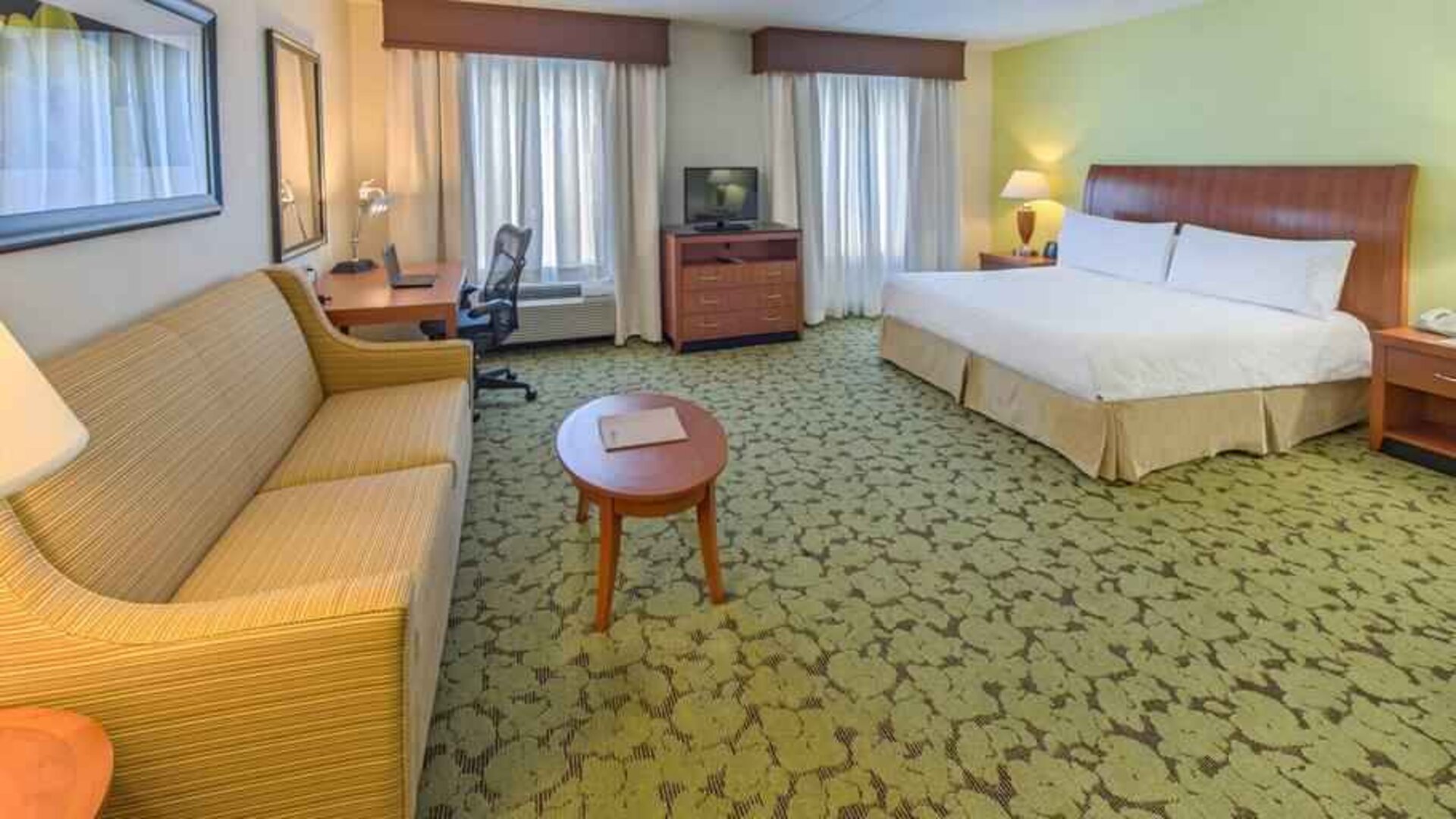 Spacious king suite with sofa and working station at the Hilton Garden Inn Tallahassee Central.