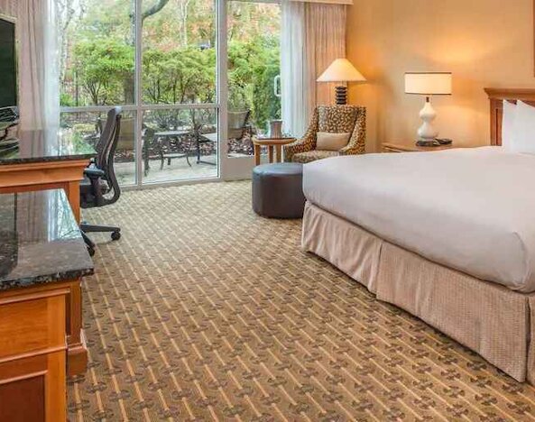 Spacious and comfortable king suite with balcony at the Hilton Seattle Airport & Conference Center.